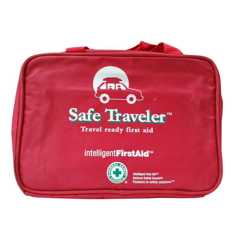 Red Firstaid case made of nylon, with symbol of car and text Safe Traveler