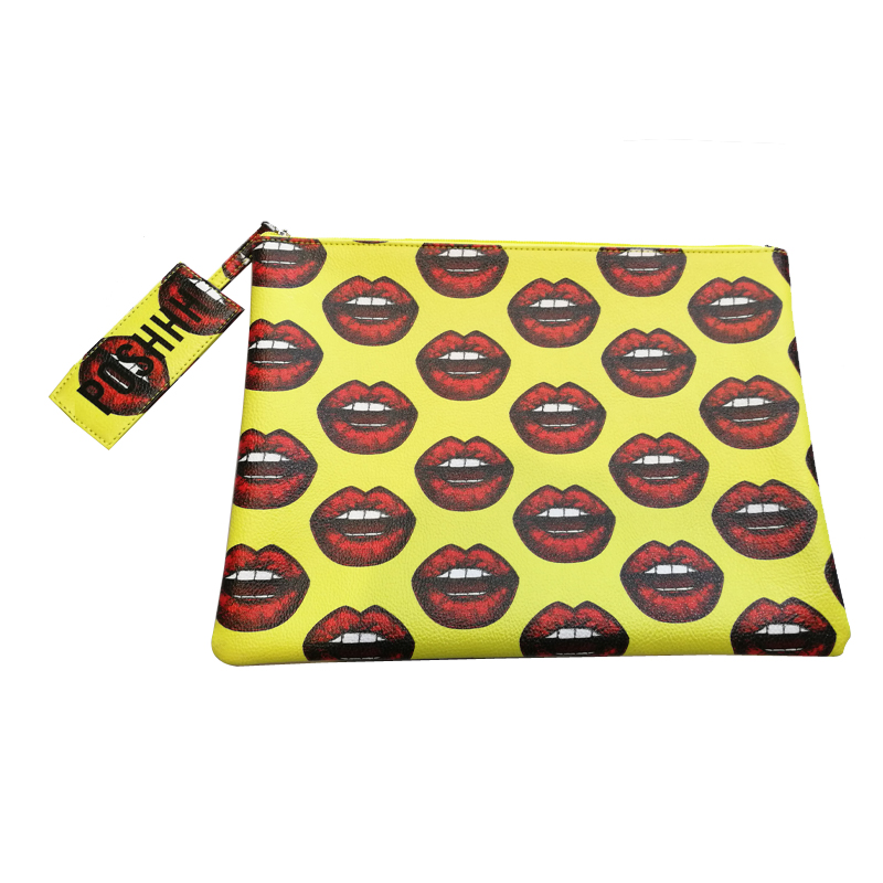 Ipad cover yellow with print of mouth with red lips and white teeth